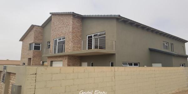 **Spacious Six-Bedroom Dual-Entrance Home with Modern Amenities**